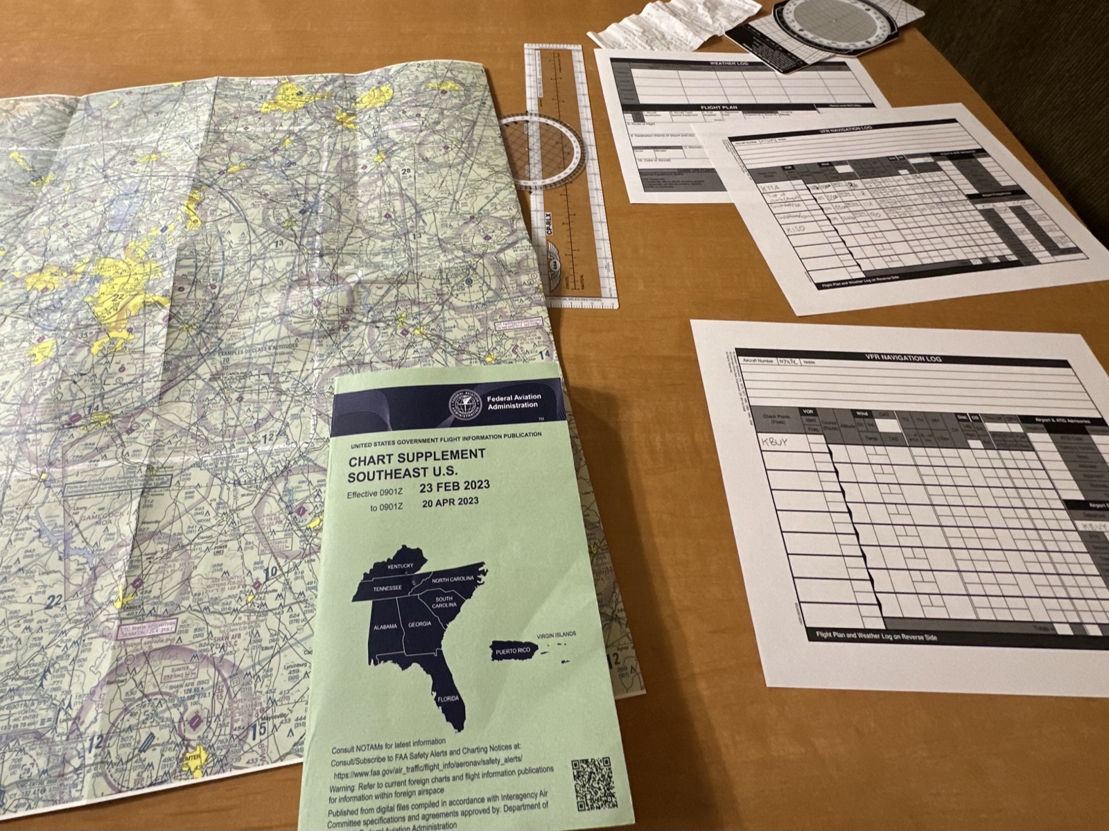 Charts and flight planning materials spread out on a table